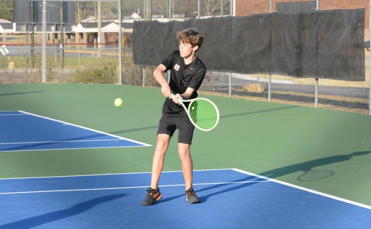 Caleb Carter returns the serve as Carter and Hudson Wise claimed the win at No. 2 doubles to help caputere a 4-1 win over the Eagles of East Jackson on March 13. (Photo/Benjamin London)