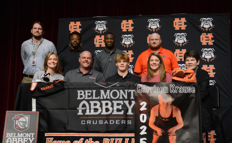 Harrison Krause (middle on first row) surrounded by family and coaches as he signs with Belmont Abbey College to continue his academic and wrestling career.