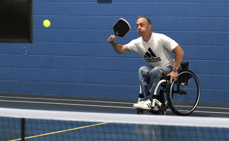 Phillip Henderson, 51, strikes a pickleball while maneuvering his wheelchair at the YMCA on Monday. Henderson, paralyzed at 14, has played sports his entire life and continues to exercise almost daily. (Photo/Adriana Cascio)