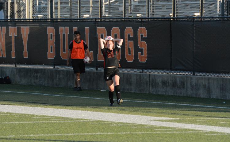Junior defender Juliette Cason throws the ball into play earlier in the season. (Photo/Benjamin London)