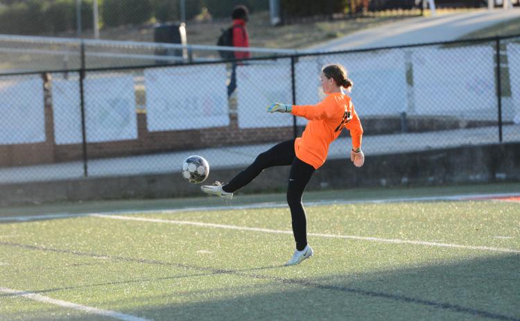 Goalkeeper Kaylin Bowers punts the ball away after a save in the 8-0 loss to Stephens County on March 21. (Photo/Benjamin London)