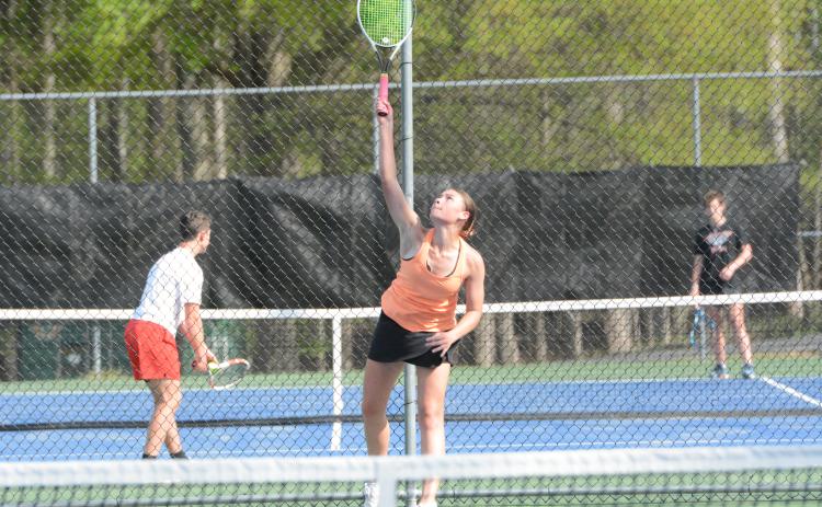 Lyla Phillips serves the ball as she picked up a 6-2, 7-5 win at No. 1 singles in the 3-2 loss to East Jackson on April 15. (Photo/Benjamin London)
