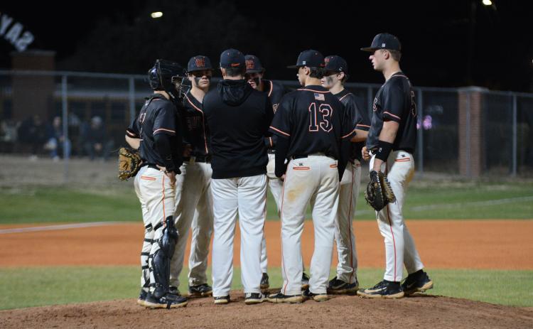 The pitcher, the infielders and head coach Hunter Barton gather at the mound as the Diamond Dogs fall into an eight-game losing streak and seven-game losing streak in region play. (Photo/Benjamin London)