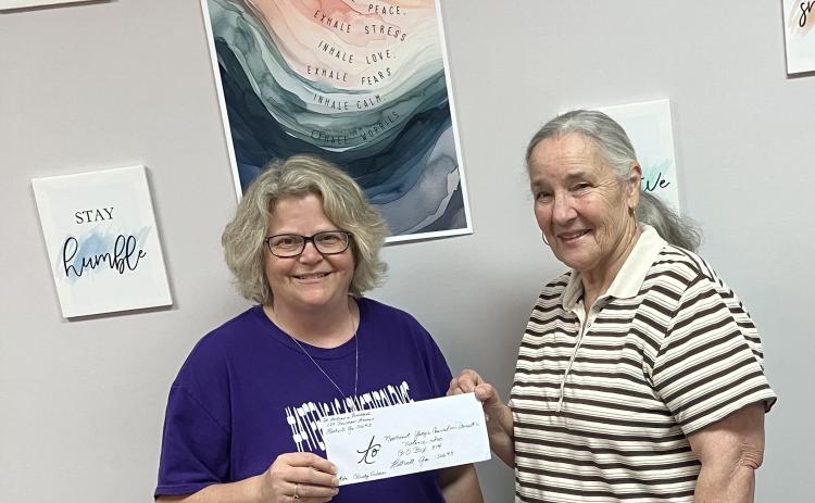 Pictured during a check presentation from St. Andrew’s Episcopal Church to the Northeast Georgia Council on Domestic Violence are (L-R) Christy Osborne of the NEGACDV and Nancy Dunn from St. Andrew’s. (Photo submitted by Rhea Dignam)