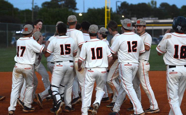 The Hart County baseball team celebrates after a 5-4 walkoff win on senior night at Saye Field on April 16. (Photo/Benjamin London)