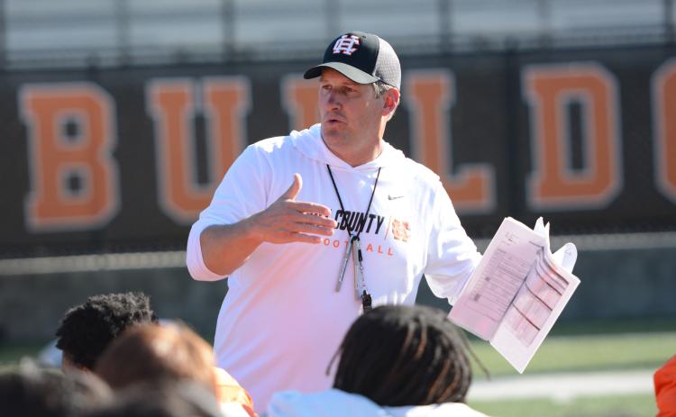 Head football coach Cory Dickerson speaks with the team after their third practice of the spring on May 6. (Photo/Benjamin London)
