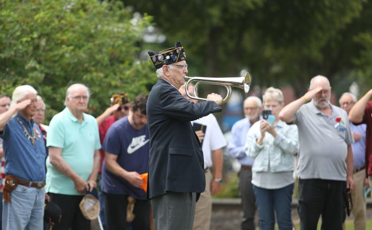 American Legion Post 109 held its annual Memorial Day ceremony Monday, May 26 at the Hart County Courthouse. Above, U.S. Air Force veteran Phil Stocks plays Taps outside the courthouse as attendees and fellow retired service men and women salute. (Photo by Rose Scoggins - Editor/Publisher)