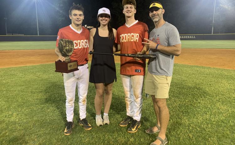Pictured from left are Diamond Dogs’ senior infielder Pearce Mewborn with the championship trophy, Lake Hartwell FCA’s Olivia Morris, Diamond Dogs’ senior infielder and pitcher Riley Kesler with the MVP trophy and Lake Hartwell FCA’s Chad Posey. (Photo/Benjamin London)