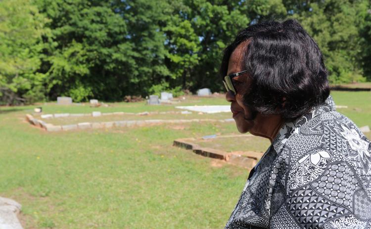 Diane Merritt, owner of surrounding land and congregant of Harmony Grove Missionary Baptist Church, looks over the historic Harmony Grove Baptist Church Cemetery. The land has been passed down through generations since Ervin Merritt, Merritt’s great-grandfather and former slave, inherited over 600 acres from the Bowers family. (Photo/Adriana Cascio)