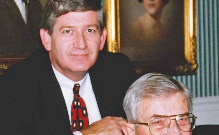This photo—taken in December 1997—was my dad’s last Christmas with us. Until our mother died in 2014, the Leon Loard portraits, in the background, of sisters Sandy and Sheila (pictured) and me always hung side by side. Today the portraits are in each of our homes. (Photo submitted by NeSmith)