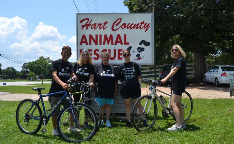 Hart County Animal Rescue (HCAR) employees and volunteers (L-R) Robert Sterling, Kristi Sterling, Sherri Lane, Maycee Lane and Lisa Oliphant pose with bicycles in front of the HCAR sign. The group is participating in 100 days of walking, running and cycling to raise awareness for the organization and struggling dogs in the Hart community. (Photo/Adriana Cascio)