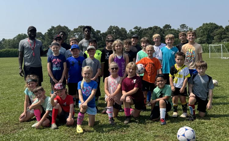 The Bell Family YMCA of Hartwell hosted more than 35 campers during their annual FUNdamental soccer camp June 2-6. Campers learned the fundamentals of soccer -- passing, dribbling and shooting, while others grew a love for the game. Pictured is all of the campers who attended with YMCA’s sports director Kerv Augustin (pictured on the back row to the left). (Photo/Adriana Cascio)