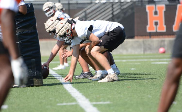 Rising senior left tackle Chris Collins lines up before the snap during a summer practice. (Photo/Benjamin London)