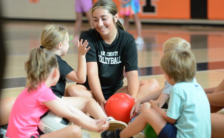 Rising junior Josee Fleming (middle) coaches her group during the annual Kids Volleyball Camp. (Photo/Benjamin London)