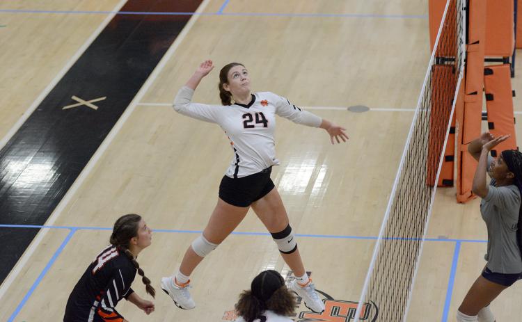 Sophomore Coley Phillips goes for the kill during a home match earlier in the season. (Photo by Benjamin London)