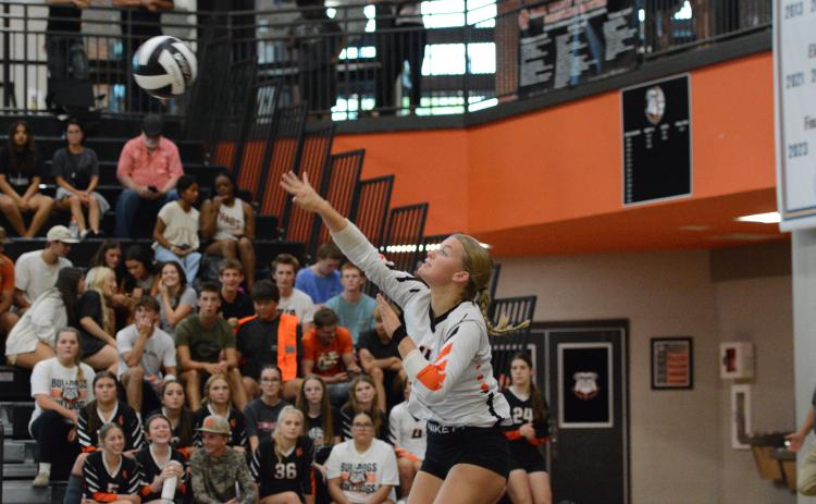 Senior libero Erin Miller serves the ball into play in the 3-0 win over Athens Christian Aug. 18. (Photo by Benjamin London)