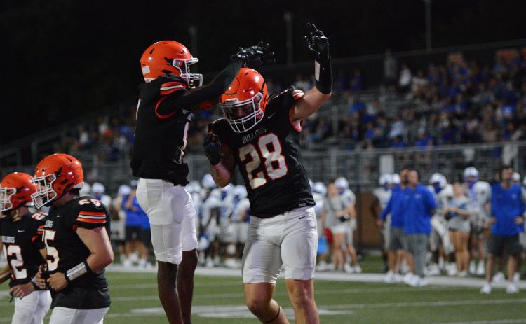 Senior tight end Boston Graham (right) celebrates with senior wide receiver CJ Cowins (left) after the touchdown in the 28-6 win over the Warriors of Oconee County in a scrimmage Aug. 8.  (Photo by London)