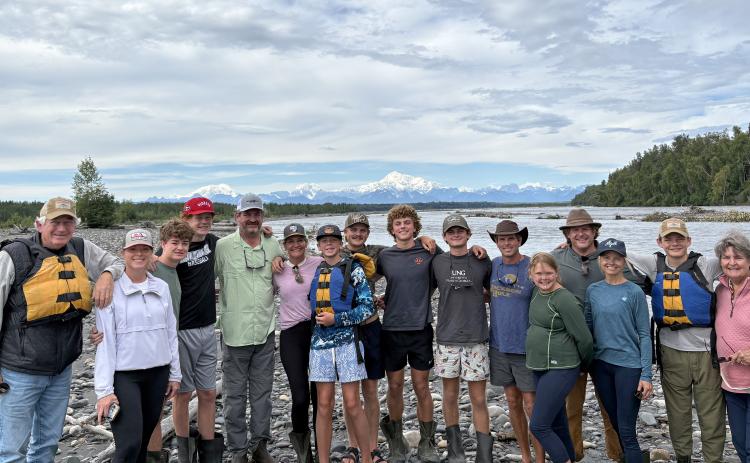 One of the highlights of the 10-day Alaska adventure was rafting down the Chulitna River in Talkeetna and getting a rare view of North America’s tallest mountain, unobstructed by clouds. With Denali, aka Mount McKinley, in the background are, from left, Dink NeSmith, Heather NeSmith, William NeSmith, Fenn NeSmith, Alan NeSmith, Emily N. Wilson, Smith Wilson, Wyatt Wilson, Henry Wilson, Hayes Wilson, Tom Wilson, Stella NeSmith, Eric NeSmith, Connell NeSmith, Bayard NeSmith and Pam NeSmith. (SubmittedNeSmith)