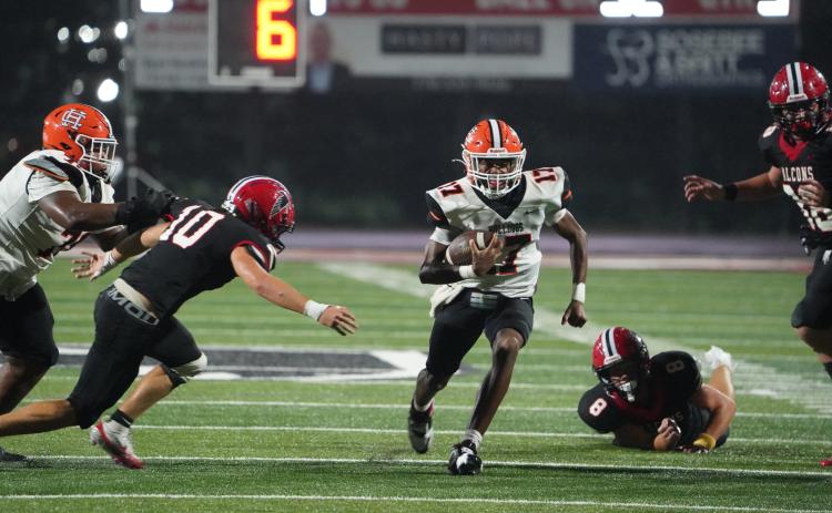 Junior quarterback Kurston Curry scores on the quarterback keeper from 32 yards out in the 24-14 loss to Flowery Branch Sept. 5. (Photo by Ric Williams)