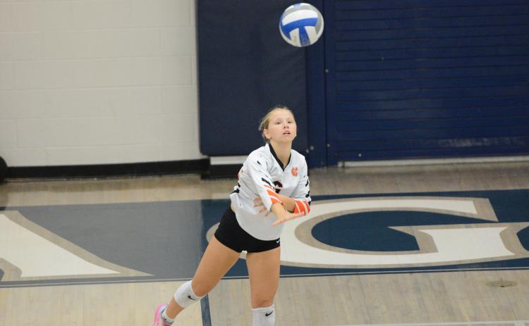 Sophomore defensive specialist Addison Coles serving the ball into play in the 2-0 win over East Jackson Sept. 25. (Photo by Benjamin London)
