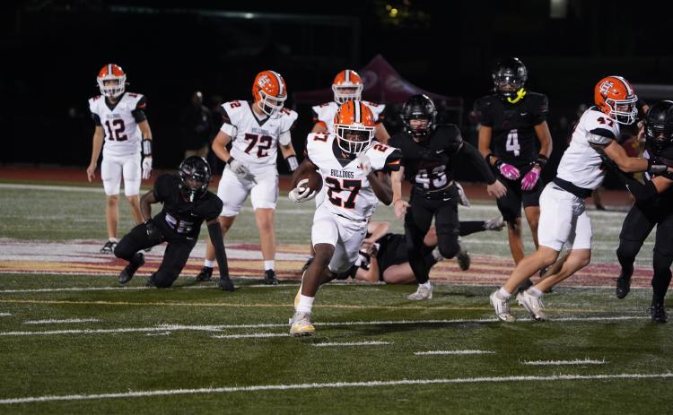 Freshman running back Ian Sheppard (27) breaks free for a late 44 yard touchdown run in the 54-10 loss to the No. 1 ranked Lions of Hebron Christian Oct. 3. (Photo by Ric Williams)