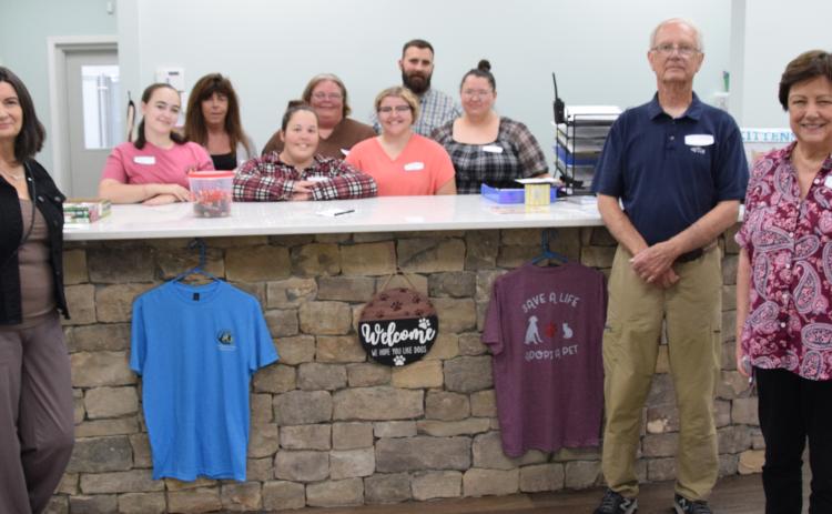 The staff at the Northeast Georgia Animal Shelter – pictured with board members Michelle Branton, John McGarity and Pam Stone – stand in the lobby of the new adoption building. The staff is available to help those looking to adopt a new dog or cat. (Photo by Shane Scoggins)