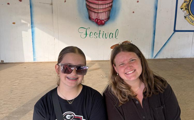 The final stop on our grand fall adventure Saturday was Ellijay’s Georgia Apple Festival. My cousin, Chloe Peace (left), and sister, Marlie Scoggins (right) posed for a photo in front of the festival stage. (Photo by Rose Scoggins)