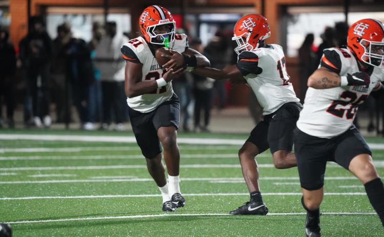 Photo by Ric Williams Junior quarterback Kurston Curry hands the ball off to junior running back Faustino Rangel who rushed for just shy of 200 yards and scored three rushing touchdowns in the 31-20 loss to Appling County Nov. 14.