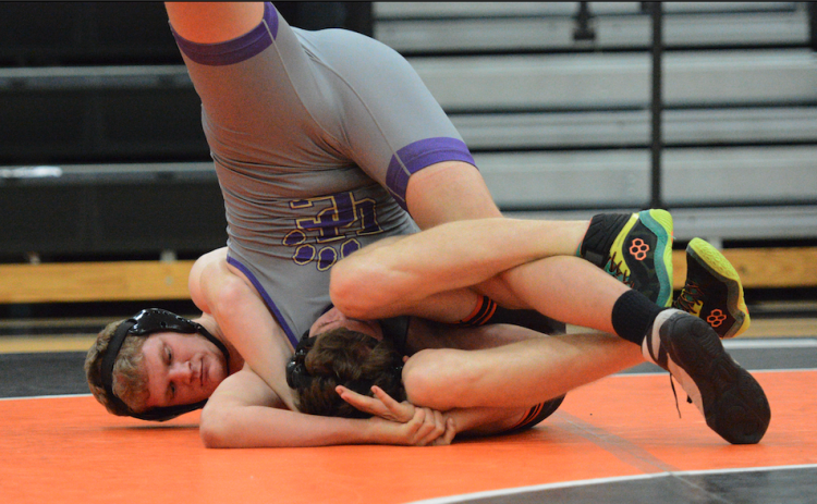 Senior Ethan Stovall pins his opponent in the 40-35 win over Union County Nov. 20 in the Dog Pound.