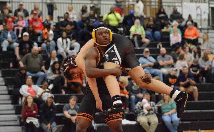 Junior Champ Blackwell goes to flip over his opponent as he ended up pinning his opponent to help the Mat Dogs capture a 73-6 win over Stephens County on senior night Jan. 6. Photo by Benjamin London.
