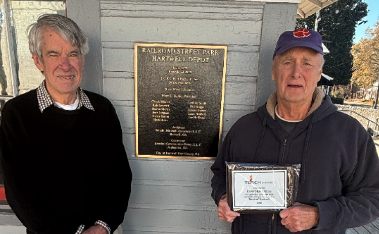 TORCH board member Larry Torrence (left) surprised outgoing fellow board member Lenford Smith (right) with a plaque for his years of service to the board. Photo by Rose Scoggins.