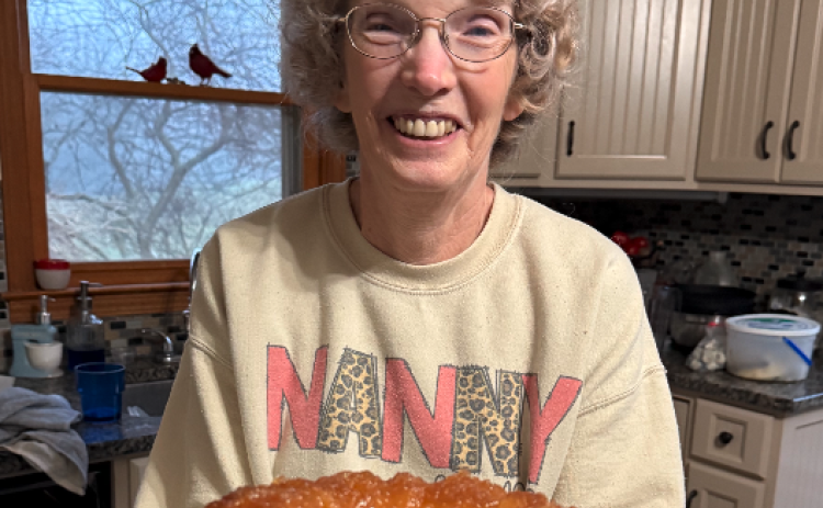 Nanny (Gail Leopard) holds our first creation this weekend – a pineapple juice cake. Photo by Rose Scoggins.