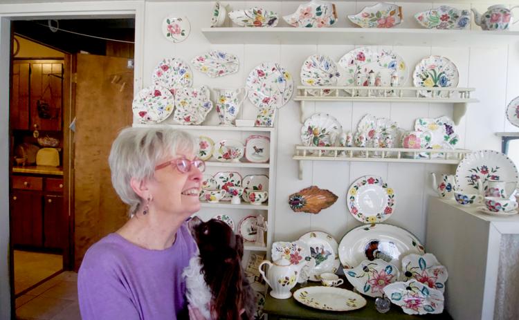 Brenda Spears, with her dog, Petey, remembers the life of her late husband, Buddy, through their mutual love of pottery and antiques. Photo by Madison Linton.
