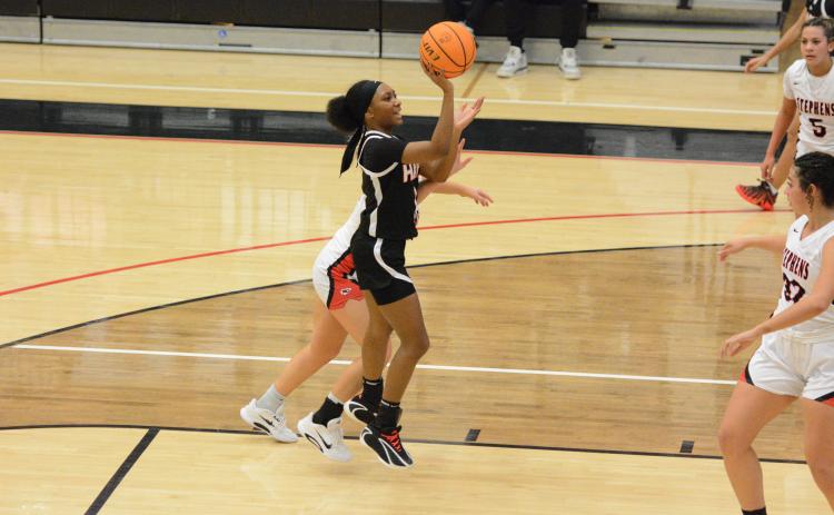 Junior guard Jaycee Wiley puts up a floater in the 63-33 win at Stephens County Feb. 10. Photo by Benjamin London.