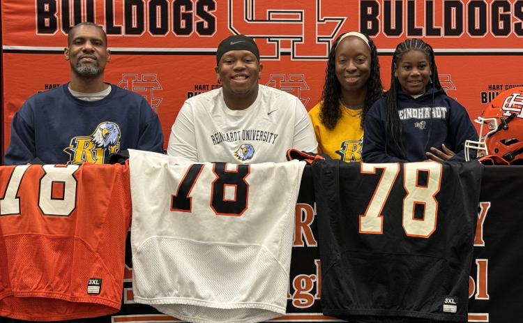 Pictured middle is Nicholas Carter with his family, as he signed with Reinhardt for football. Photo by Benjamin London.