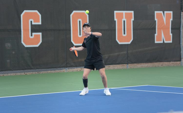 Riley Gaines returns a serve in the 5-0 win against Elbert County Feb. 9, as he remaines undefeated through three matches at No. 3 singles. Photo by Benjamin London.