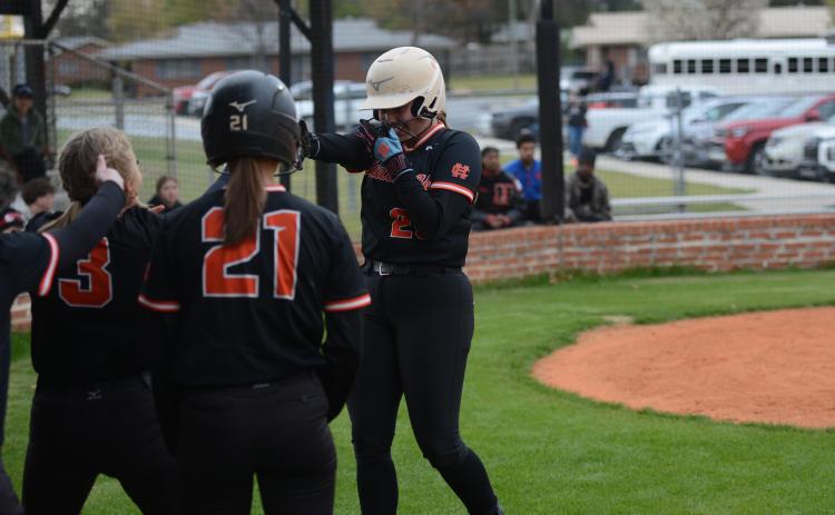 Chesnee Strickland (right) celebrates with her teammates after hitting a three-run home run to start the 21 run inning in the 21-1 game two  win against Hancock Central March 18. Photo by Benjamin London.