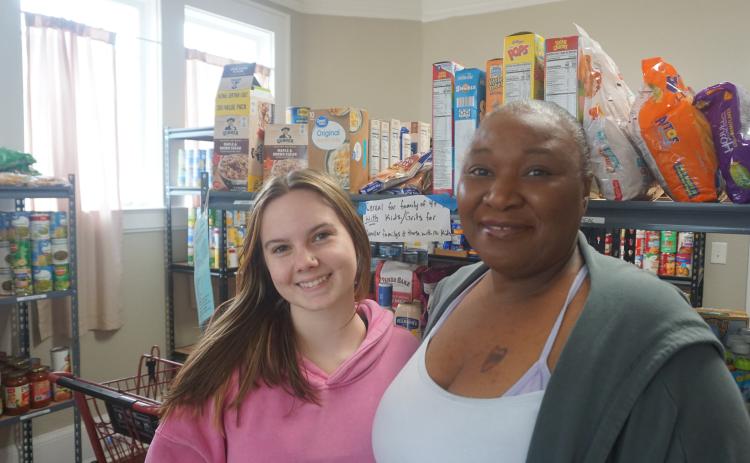 Assistant director Beth Mason and director Keisha Henry stock shelves at the Hart County Food Pantry on Mondays. The pantry offers perishable and non-perishable goods. Photo by Madison Linton.