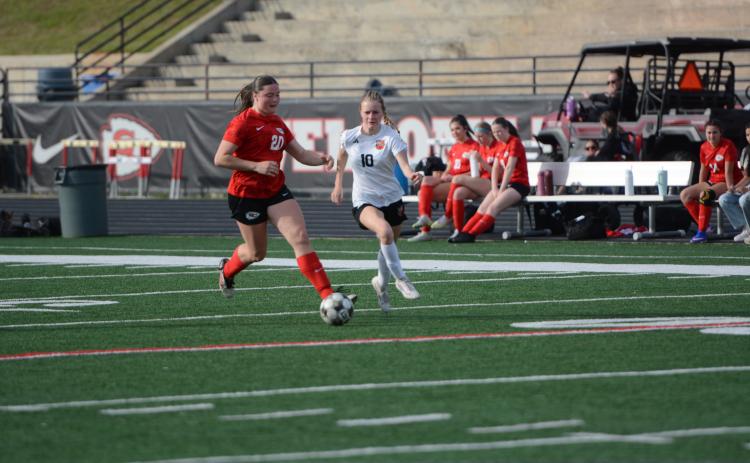 Forward Isla Bell (right) battles against a Lady Indians defender in the 2-1 road loss to Stephens County March 20. Photo by Benjamin London.