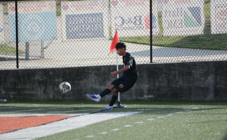 Midfielder Johan Santos Perez sends the ball into play earlier in the season, as he scored goal and collected an assist in the 3-0 win over East Jackson March 13. Photo by Benjamin London.