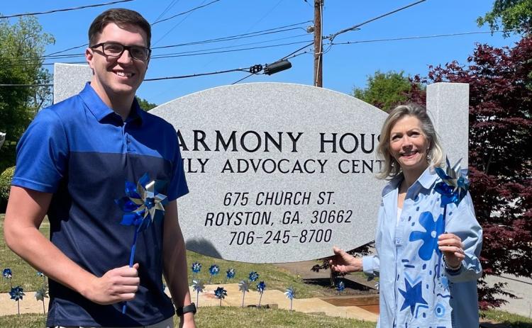Harmony House's Darrin Haley, director of clinical services, (left) and Laurie Whitworth, executive director (right) wore blue and held pinwheels outside the organization's Royston office in recognition of Child Abuse Awareness Month earlier in April. The organization, which serves the counties that make up the Northern Judicial Circuit, including Hart County, serves victims of sexual assault and abuse across all ages. Photo courtesy of Harmony House Child Advocacy and Sexual Assault Center.