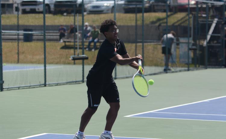 Derrick Campbell returns a serve, as him and Carson Hart dominated No. 2 doubles, 6-0 and 6-0, to help capture a 5-0 win over Hardaway April 22. Photo by Benjamin London.