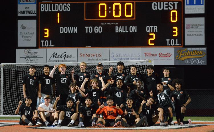 Photo by Benjamin London The Hart County High School boys soccer team celebrates after their historic 1-0 win over the Lions of Hebron Christian March 31, as they set school history capturing their 13th win of the season. Photo by Benjamin London.