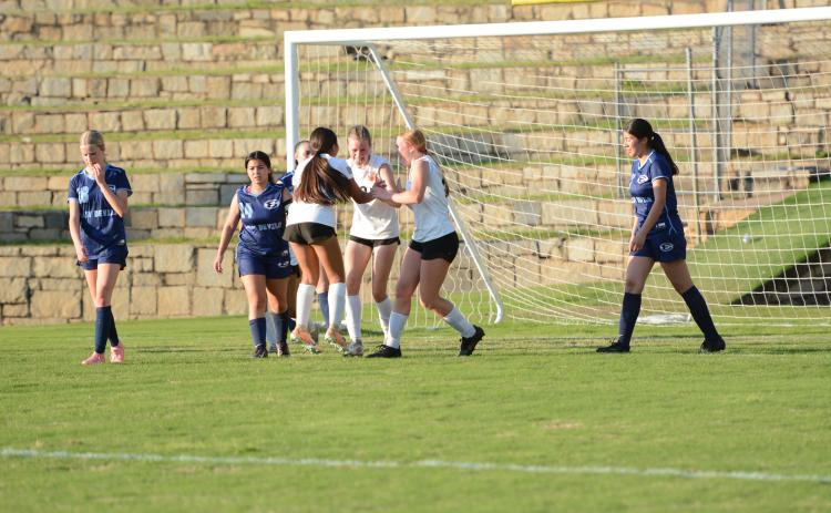 Isla Bell (middle) celebrates with her teammates after scoring a late goal in the 5-2 win over Elbert County April 14.  (Photo by Benjamin London)