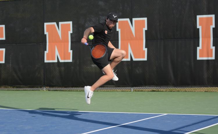 Senior Riley Gaines returns a serve in the 4-1 win over the Indians of Stephens County on senior night March 26. Photo by Benjamin London.