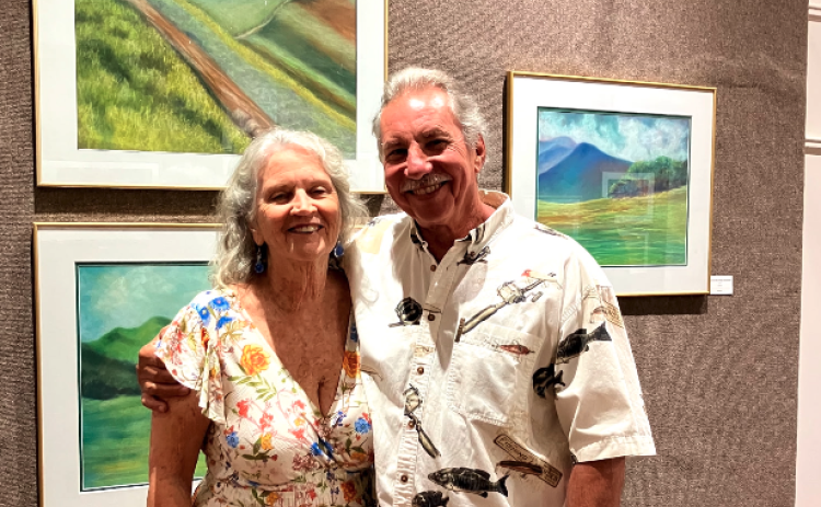 Pictured during the opening night of Nancy Duckworth's display at the Hartwell Art Center are (L-R) Duckworth and her husband, John Atkinson. Her display, "Earth's Beauty: Lands, Waters, Skies" is open through May 16.  Photo submitted by Nancy Duckworth.