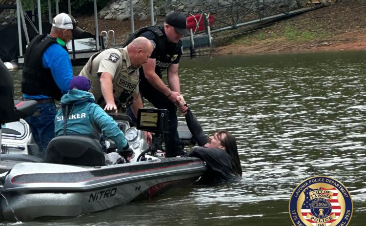 Hart County Sheriff's Office Cpt. Matt Gulley helps the Lavonia Police Department retrieve a suspect out of the waters of Lake Hartwell in Gumlog following a stolen car chase May 24.  Photo courtesy of the Lavonia Police Department. 