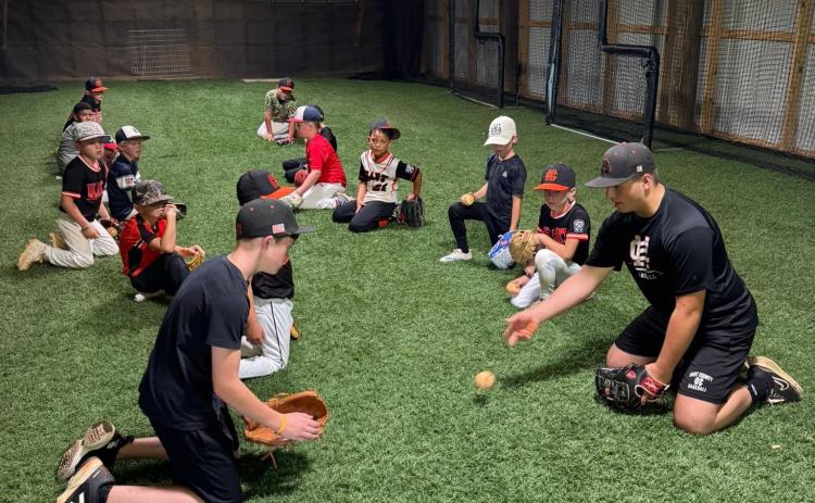 High school and middle school players help lead a fielding drill at the annual Youth Baseball Camp June 22-24. Photo submitted by Hart County Baseball. 