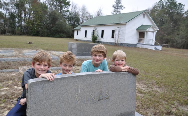 In 2017 four of our eight grandchildren visited the graves of their ancestors at Pilgrims Home Free Will Baptist Church on Hwy. 91 in Baker County, Georgia. The Wilsons are, from left, Hayes, Henry, Wyatt and Smith. They are posing by the granite tombstone of my mother’s parents, Howell and Essie (Nanny) Vines. Photo submitted by Dink NeSmith.