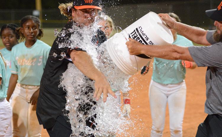 Hart County Little League’s president and the Senior League softball team’s manager Mason Bowers receives a ice bath after capturing their fourth straight state title to advance to the Southeast Regional July 24-27. Photo by Benjamin London.